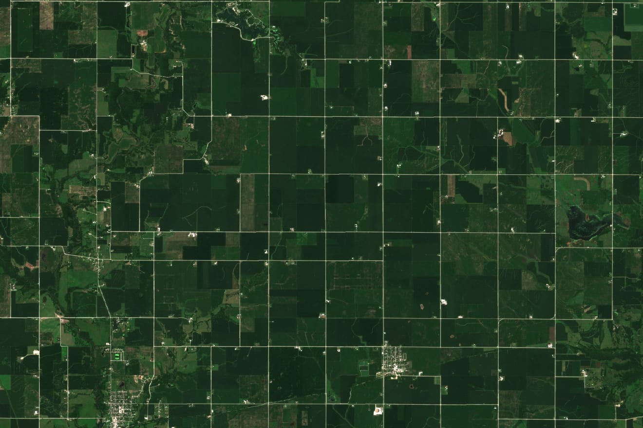 Natural-color satellite image, 18 by 12 kilometers: fields on the one-mile road grid near Collins and Maxwell, in Story County, Iowa (United States), on July 14, 2025.